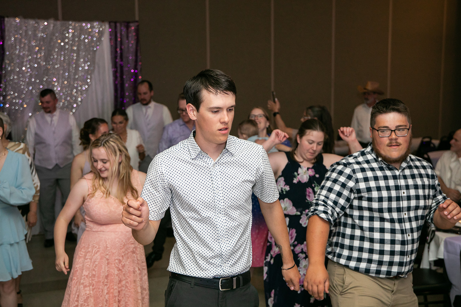 Guests of all ages dancing together at a wedding reception